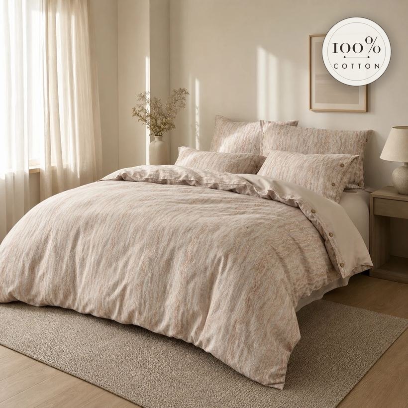 Alabaster sand marbled cotton duvet set with 100% cotton seal, styled on a bed in a calm, sunlit bedroom